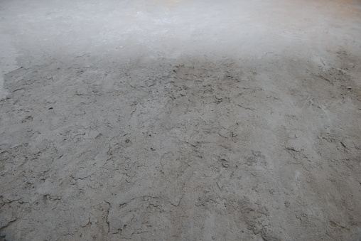 Uneven surface filled with a cement-sand mixture of gray color