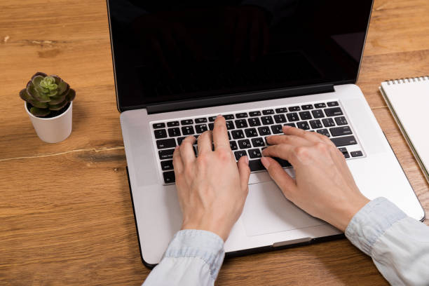 istock Hands close-up. Working on a computer, laptop. Office background. Online work. Typing 1318609703