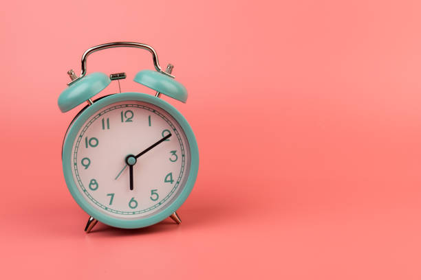 istock Old clock isolated on a pink background with space for text. Concept of time 1318610327