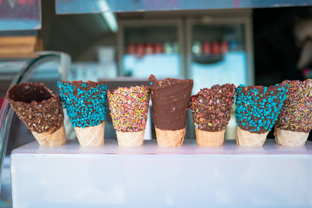 istock Selection of chocolate covered ice cream cones in a row 1318611678
