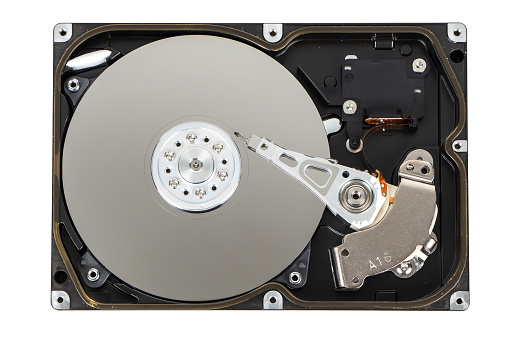 Close up inside of computer hard disk drive HDD isolated on white background.