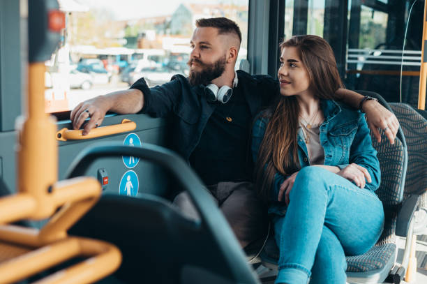 istock Young romantic couple sitting in a moving bus 1318613467