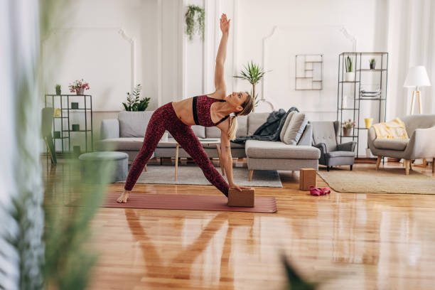 istock Woman doing yoga at home 1318613515