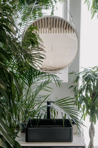 istock Round mirror above wash basin in bohemian bathroom 1318614747