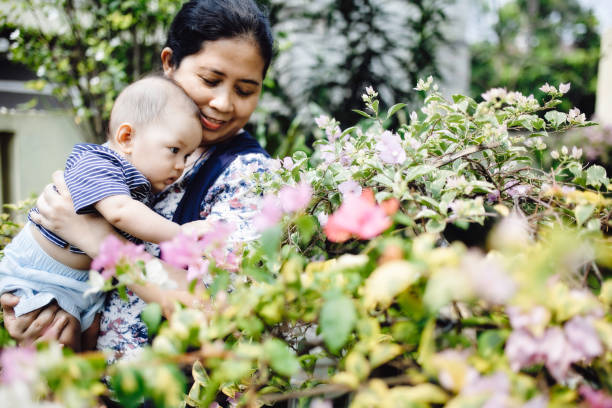 istock mother with baby playing in the park 1318615117
