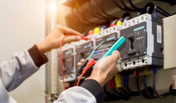 istock Electrical engineer tests the operation of the electric control cabinet on a regular basis for maintenance. 1318616429
