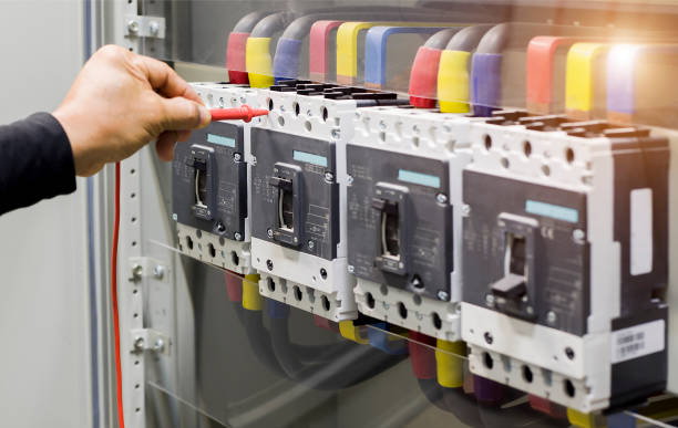 istock Electrical engineer tests the operation of the electric control cabinet on a regular basis for maintenance. 1318616453