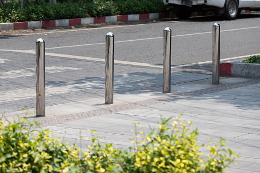 stainless steel bollards at concrete pavement.