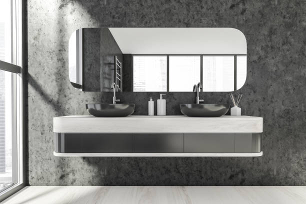istock Bathroom interior with two sinks and mirror on dark grey wall near window 1318621366