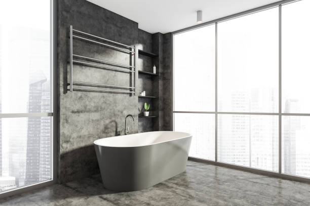 istock Bathroom interior with bathtub near window on concrete floor 1318621461