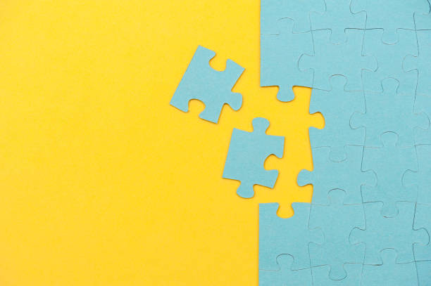 istock Blue puzzle background with missing piece on yellow background. Top view 1318622979