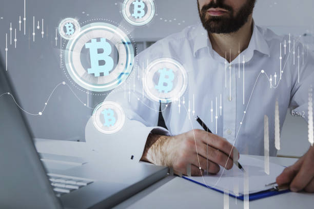 istock Businessman wearing suit is looking at laptop and making notes 1318623901