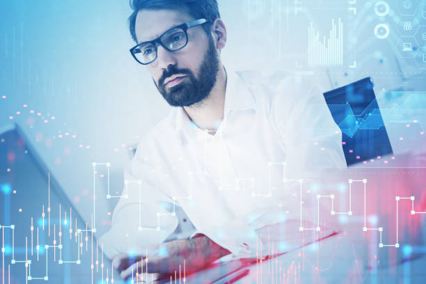 istock Businessman in eyeglasses working with laptop, graph changes and network icons 1318624040