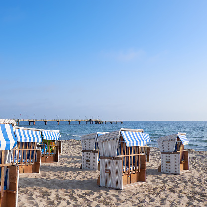 Sandy beach and beach chairs in Rugen, an island on the coast of Baltic Sea in Northern Germany. Square composition.