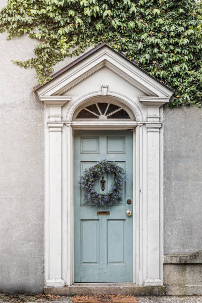 Picture perfect robin's egg blue front door with wreath and greenery Picture perfect robin's egg blue front door with wreath and greenery for a classic architecture look. blue front door stock pictures, royalty-free photos & images