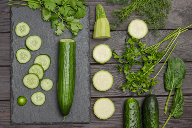 istock Sliced cucumber, cilantro on cutting board. 1318628862