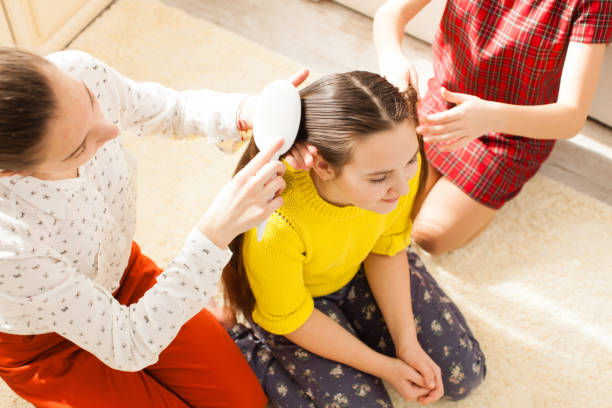 Mother Combing Hair Of Daughter At Home Photo taken in Ukrainets, Ukraine  Hair Oil for Kids stock pictures, royalty-free photos & images