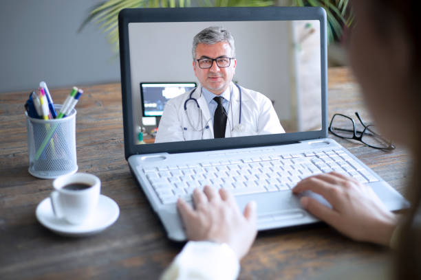 istock doctor and woman patient online talking on computer 1318629794