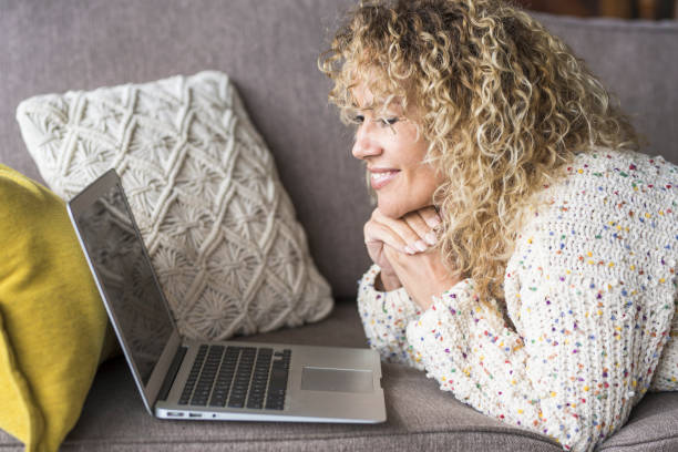 istock Midsection Of Woman Using Mobile Phone While Sitting On Sofa 1318630768
