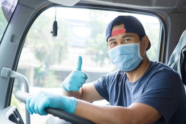 istock Truck drivers wear protective mask while driving. 1318633711