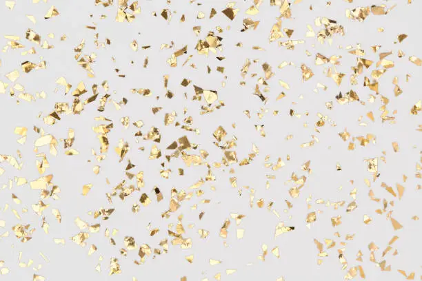Gold confetti sparkles on white background. Golden foil, festive backdrop. Chic Birthday party.