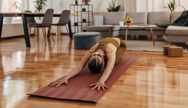 istock Woman doing yoga at home 1318636687