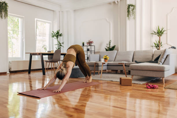 istock Woman doing yoga at home 1318636865