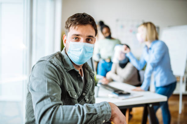 istock Multi ethnic business team in office, wearing face masks 1318638638