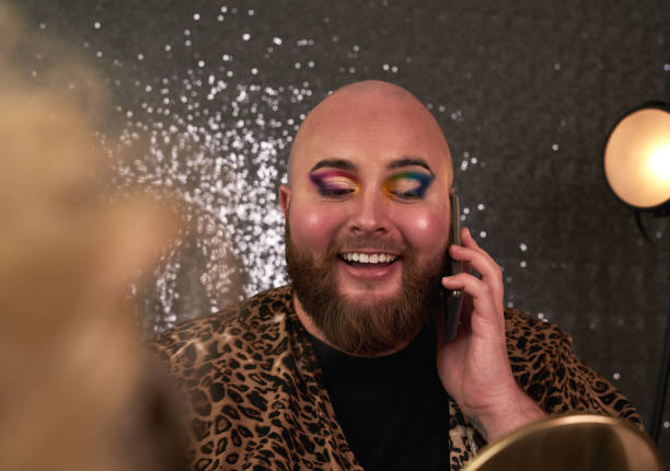 istock Shot of a young man using a smartphone while applying theatrical makeup in a studio 1318638729