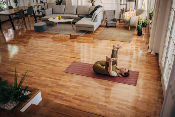 istock Woman doing happy baby exercise 1318640780