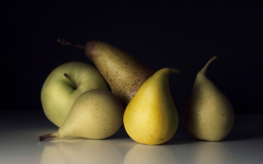 Fresh pears in male hands. Juicy flavorful pears in box, basket. Organic fruit for food or pear juice. Healthy food. Pear harvest.