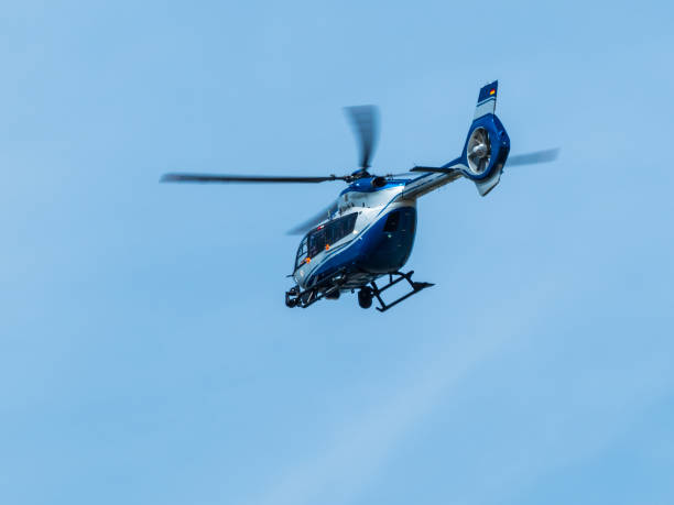 istock Blue helocopter in blue sky 1318648453