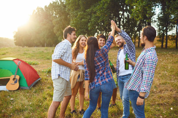 istock Young people are smiling cheerfully while standing on the grass on picnic 1318651211