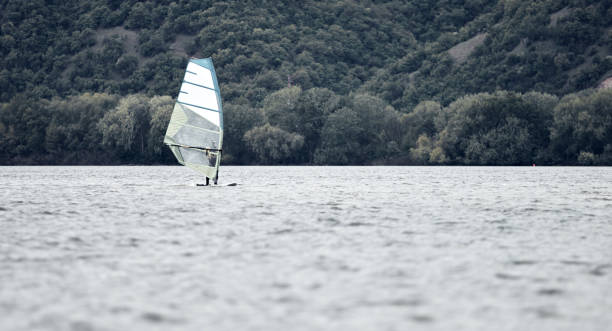 istock Windsurfer surfing on a windy day at the river. 1318654057