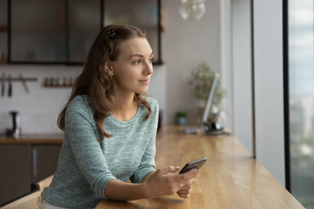 istock Pensive woman use cellphone thinking or making plans 1318654289