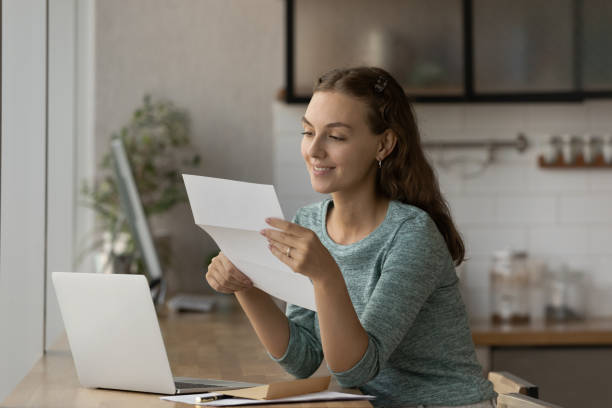 istock Smiling female employee get pleasant postal message 1318654325