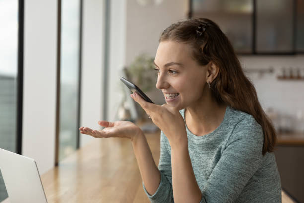 istock Smiling woman talk on loudspeaker on cellphone 1318654329