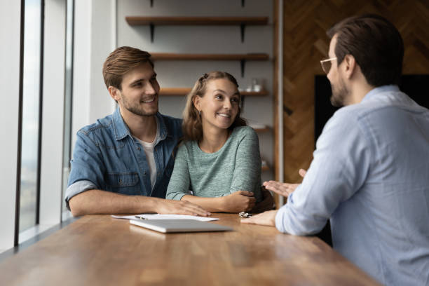 istock Happy couple have consultation with relator in office 1318654371
