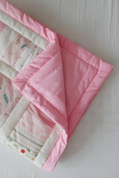 istock Pink patchwork blanket. Baby bedding. Bedding and textile for nursery. Nap and sleep time 1318655432