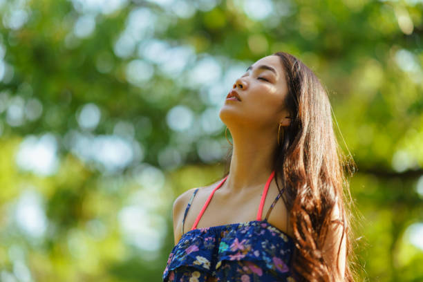 istock Young woman standing on tree trunk barefoot and relaxing in nature 1318655729