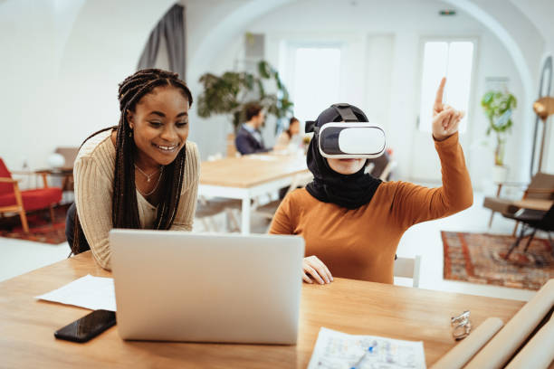 istock Multi ethnic businesswomen working in office and creating architectural renders with VR glasses 1318656836