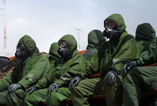 Setubal, Portugal: Portuguese soldiers - elite troops of the Fuzileiros (Marines) wearing NBC (nuclear, biological, chemical) suit, also called a chemsuit  or chemical suit - military personal protective equipment.