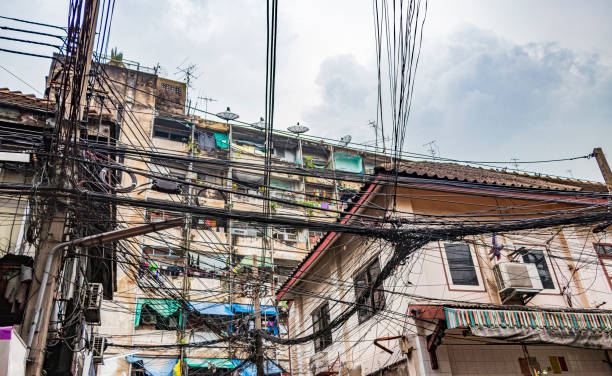 istock Absolute cable chaos on Thai power pole in China Town Bangkok Thailand. 1318659119