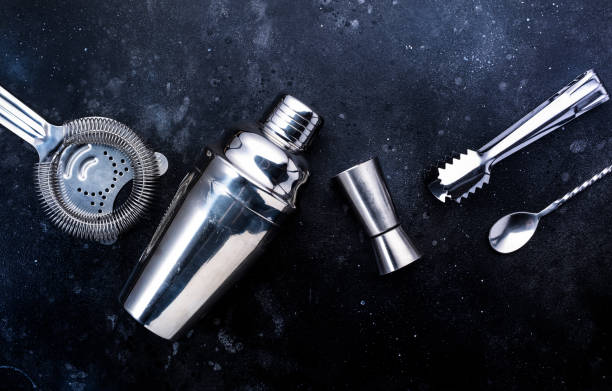istock Steel bar tools and accessories for making cocktail. Shaker, jigger, strainer, spoon, tongs, muddler. Alcohol drink and beverages preparation 1318664023