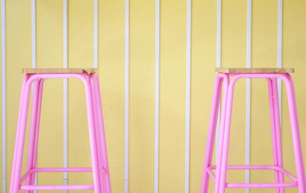 istock Pink chairs on a yellow pastel background. 1318664802