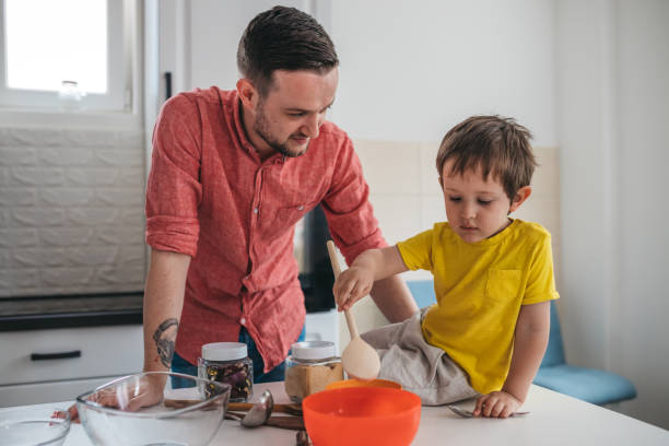 istock Father and son prepare food in the kitchen 1318664993