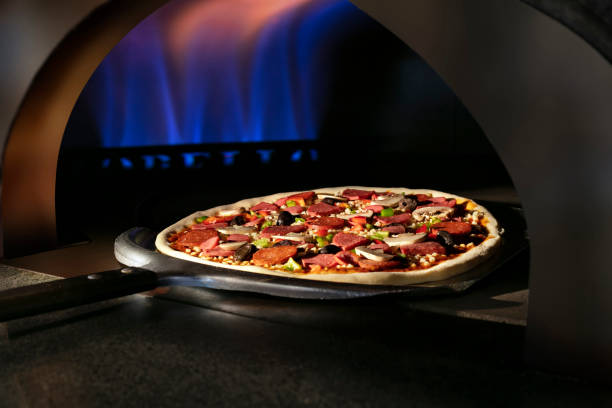 istock Baked pizza in stone oven. 1318665325