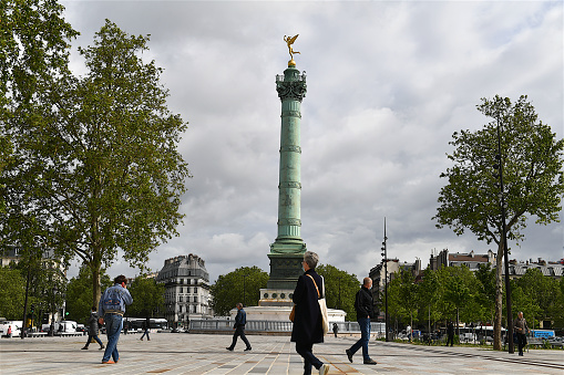 Paris, France-05 18 2021:People walking on the Place de la Bastille, which is a square where the Bastille prison stood until the storming of the French Revolution.No vestige of the prison remains.The July Column stands at the center of the square.