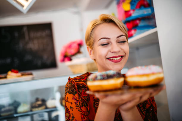 istock Woman looking at donuts at the bakery store 1318666219