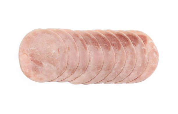 Slices of poultry ham sausage - in a row - against white background
